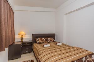 a bedroom with a bed and a dresser and a lamp at Apartment Ines in Bar