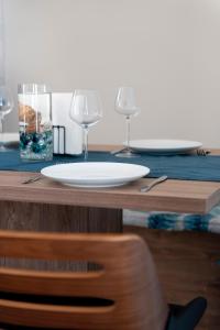 a plate on a table with two wine glasses at Alimbali Villas in Karpathos