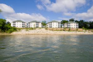 a row of houses on the banks of a river at The Suites at Fall Creek in Branson