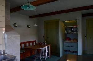 a kitchen with a table and a dining room at Stylish Swedish farmhouse in Borrby