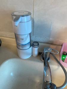 a coffee maker sitting on a counter next to a sink at Casa Daia in Resistencia +10 photos