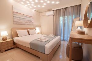 a bedroom with a large bed and a window at Agnes by RentalsPro - Nea Moudania Halkidiki in Nea Moudania
