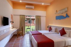 贝托贝提姆Jasminn Hotel - AM Hotel Kollection的有两张床和一台电视的酒店房间