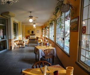 a restaurant with tables and chairs and windows at Hotel Bellavista in San Bartolomeo al Mare