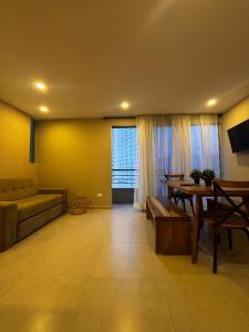 a living room with a couch and a table at APARTAMENTO BETANIa in Armenia