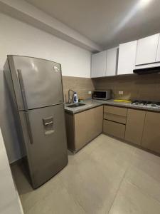 a kitchen with a stainless steel refrigerator at APARTAMENTO BETANIa in Armenia