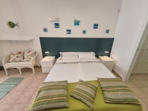 a large bedroom with two beds and two chairs at Monolocale Santa Caterina in Santa Caterina di Nardò