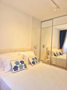a bedroom with a bed with two pillows on it at Sea Colours Apartment Budva in Budva