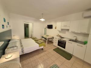 a small bedroom with a bed and a kitchen at Monolocale Santa Caterina in Santa Caterina di Nardò
