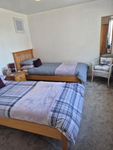 Postel nebo postele na pokoji v ubytování Coorie Braw Cottage
