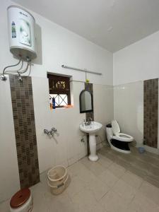 a bathroom with a toilet and a sink at Country Side Home Stay In House in Rānīkhet