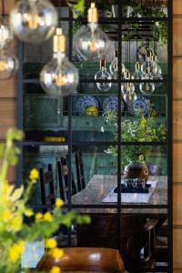 a dining room with a table and chairs and lights at Siedlisko Dańce 91 