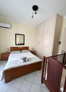 a bedroom with a large bed and a mirror at Alexandroupolis Lighthouse Apartment P!!! in Alexandroupoli