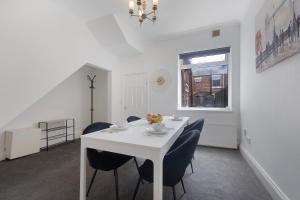 a white dining room with a white table and chairs at Your Home Away in Bishop Auckland +6 photos