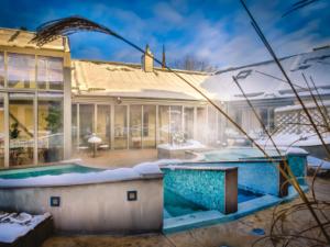 a house with a swimming pool in front of it at Vadstena Klosterhotell Konferens & Spa in Vadstena