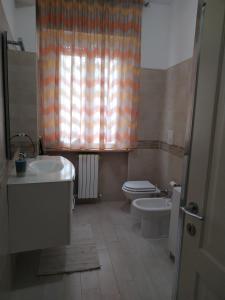 a bathroom with a toilet and a sink and a tub at Casa Mari in Ancona