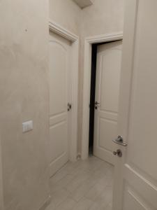 a hallway with two doors and a tile floor at Casa Mari in Ancona