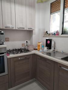 a kitchen with wooden cabinets and a stove top oven at Casa Mari in Ancona