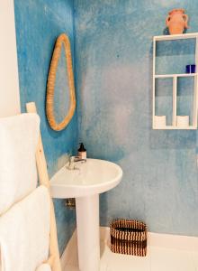 a bathroom with a sink and a mirror at Blue Kaouki in Sidi Kaouki +83 photos