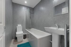a white bathroom with a sink and a toilet at Your Home Away in Bishop Auckland