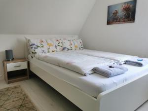 a white bed with pillows on it in a room at Ruhe am Walde in Meschede