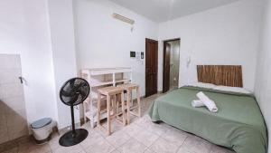 a bedroom with a bed and a fan in it at Andino Temporarios in Salta