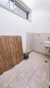 a bathroom with a wooden fence and a sink at Andino Temporarios in Salta
