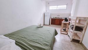a kitchen with a bed with a stuffed animal on it at Andino Temporarios in Salta
