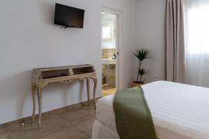 A television and/or entertainment centre at Moorea Boutique - Only Adults