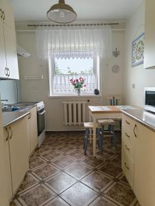 a small kitchen with a table and a window at Apartament 2pokojowy ,pokoje in Lubkowo