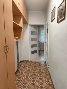 an empty hallway with a door and a tile floor at Apartament 2pokojowy ,pokoje in Lubkowo