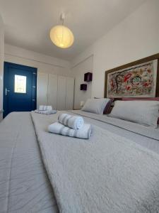 a bedroom with two beds with towels on them at Socrates House Kythnos in Kithnos