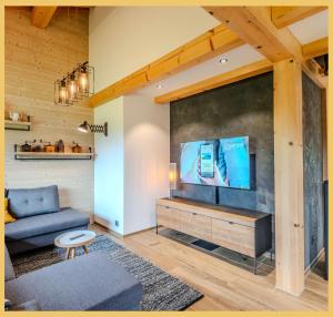 a living room with a large flat screen tv at Le Sylvana I T4 I Abondance in Abondance