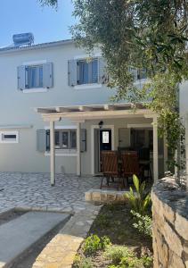 a house with two chairs and a patio at Geropalas Spacious Garden House in Vlachopoulátika