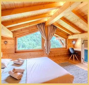 a bedroom with a bed in a wooden cabin at Le Sylvana I T4 I Abondance in Abondance