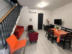 Una sala de estar con un sofá, una mesa y sillas. en Tiny House, en Funchal