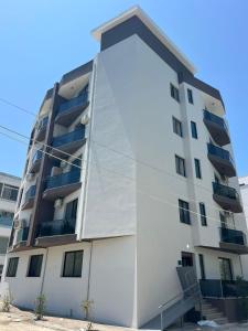 an apartment building with a white facade at Seaside Escape Apartment 1 in Golem