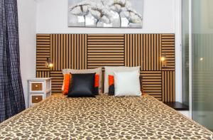 a bedroom with a large bed with pillows at Bayview Old Town Beach Apartment in Albufeira +25 photos