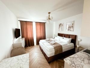 a bedroom with a large bed and a chair in it at Sali Homes - Wahnfried No 6 in Bayreuth