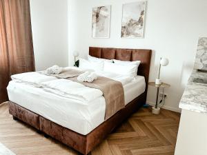 a bedroom with a large bed with towels on it at Sali Homes - Wahnfried No 6 in Bayreuth +3 photos