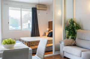 a small room with a bed and a couch at Bayview Old Town Beach Apartment in Albufeira