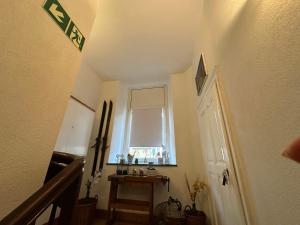 a hallway with a staircase and a window and a door at Landgasthof Zur Sonne in Enkirch