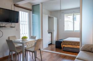 a room with a table and a bed and a mirror at Bayview Old Town Beach Apartment in Albufeira