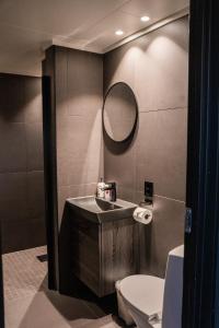 a bathroom with a sink and a toilet and a mirror at Hemsedal Cafe Skiers Lodge in Hemsedal +117 photos
