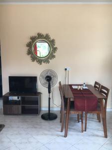 a dining room with a table and a mirror at Lazy Hill Bungalows in Bel Ombre