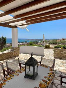 a patio with a table and chairs with a view of the ocean at Rose's House in Grótta