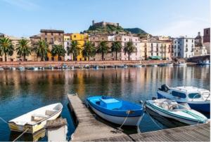 a group of boats docked at a dock in a harbor at Casa Anna in Bosa