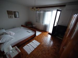 a bedroom with a bed and a flat screen tv at House with a garden 50m from the sea in Pag