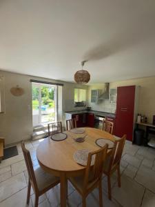 a kitchen and dining room with a table and chairs at Gîte à la campagne in Le Mesnil-Villeman +15 photos