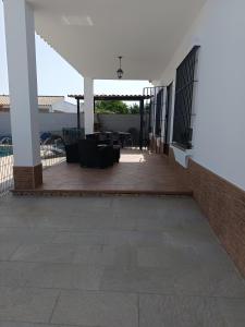 a patio with chairs and tables in a building at Lakuarta in Hozanejos